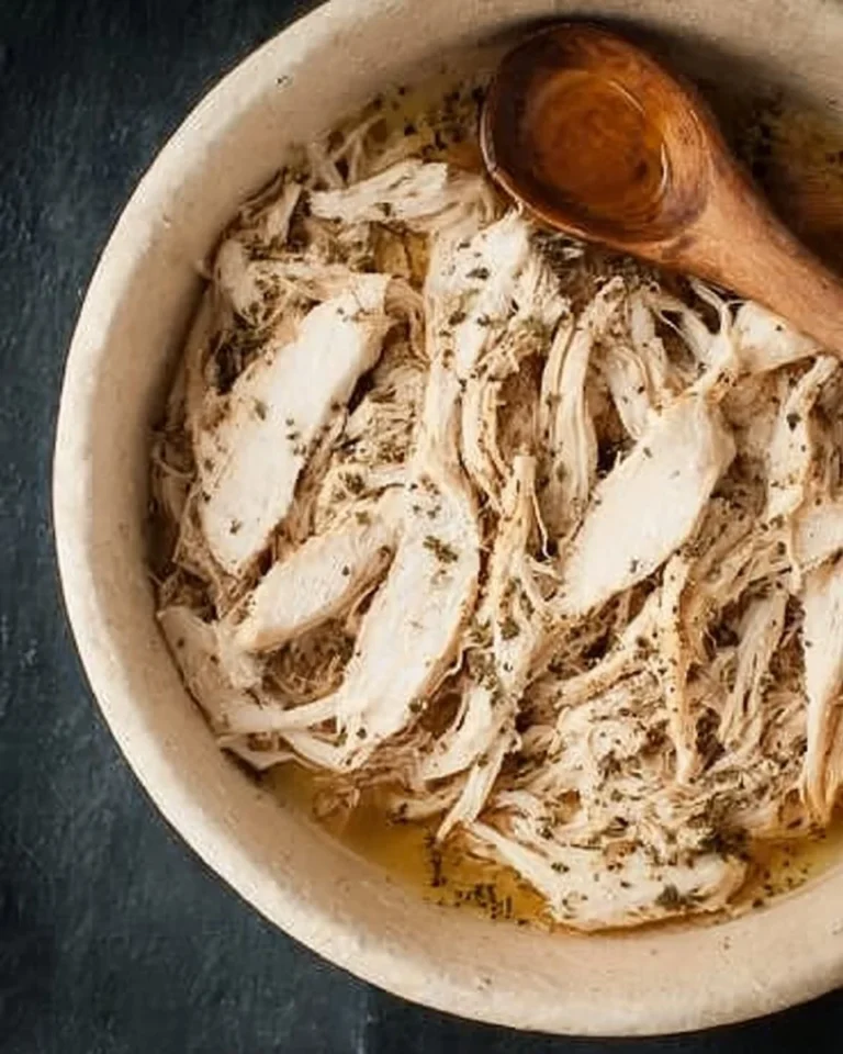 Crockpot shredded chicken in a slow cooker, ready to serve