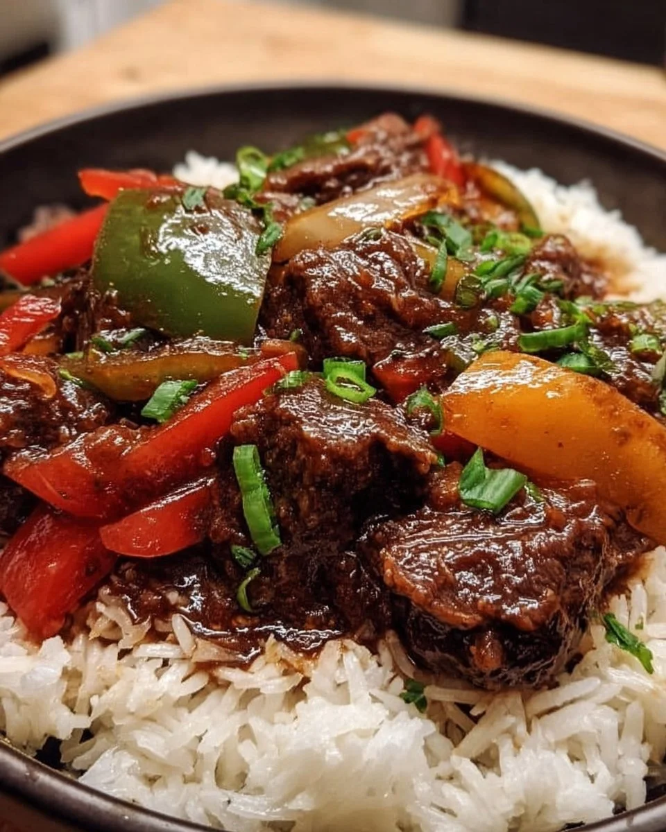 Delicious slow cooker pepper steak served with bell peppers and rice.