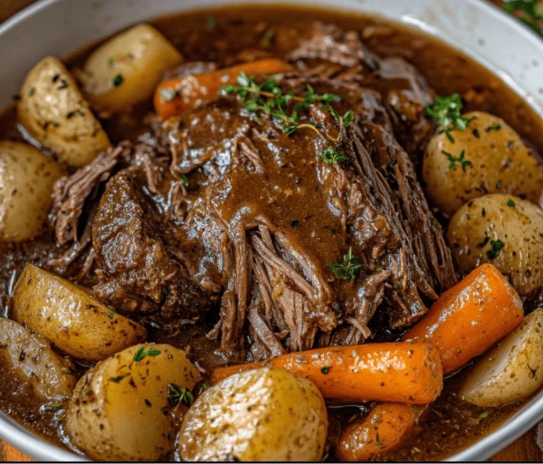 Delicious crockpot pot roast served with vegetables and herbs