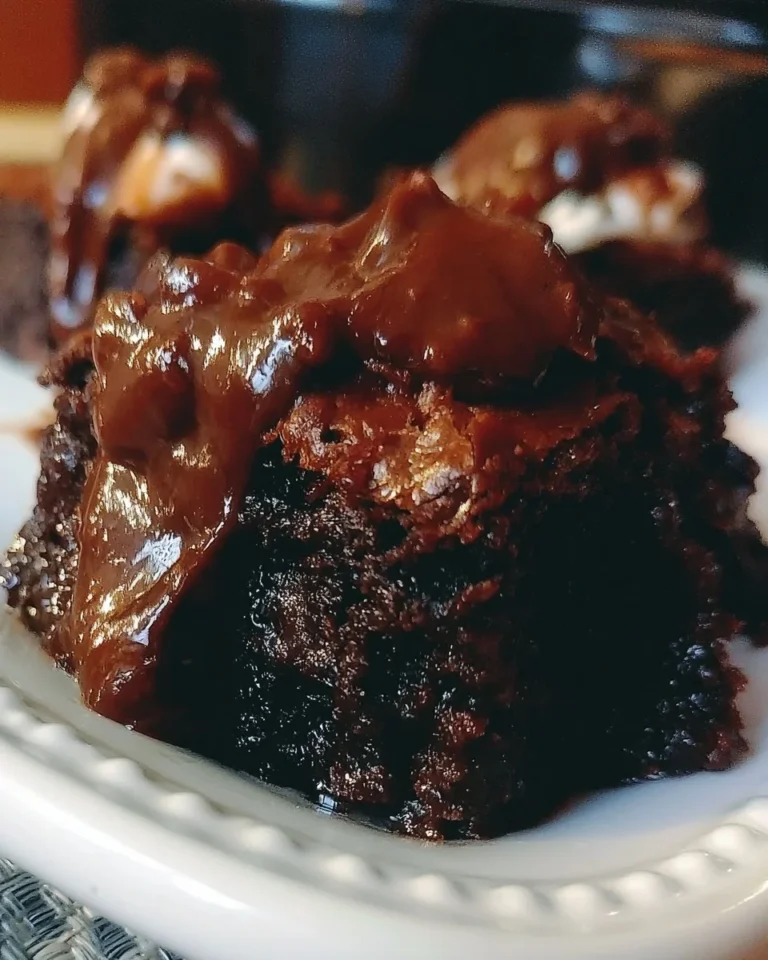Delicious Crock Pot hot fudge brownies served warm with a scoop of vanilla ice cream