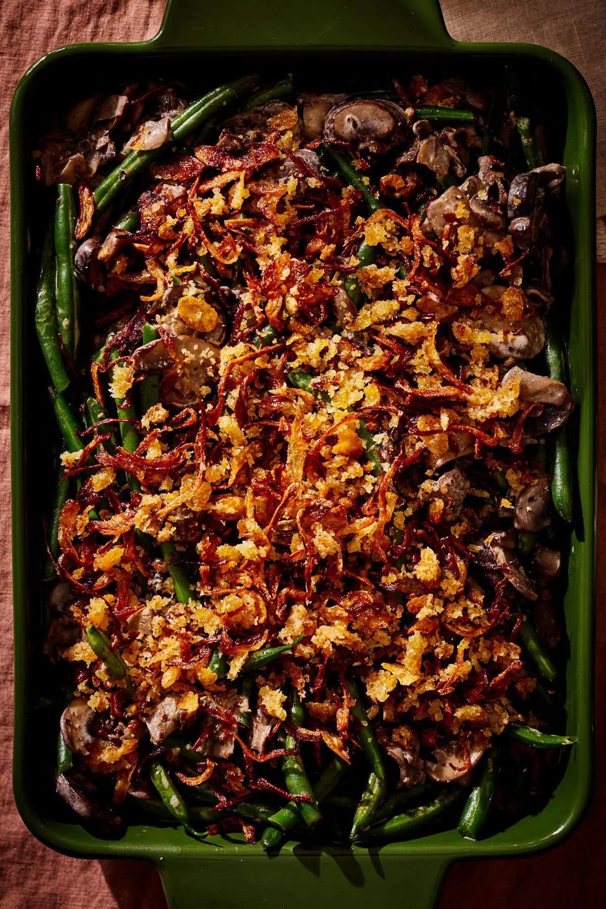 Crockpot Green Bean Casserole prepared with creamy sauce and crispy onions.