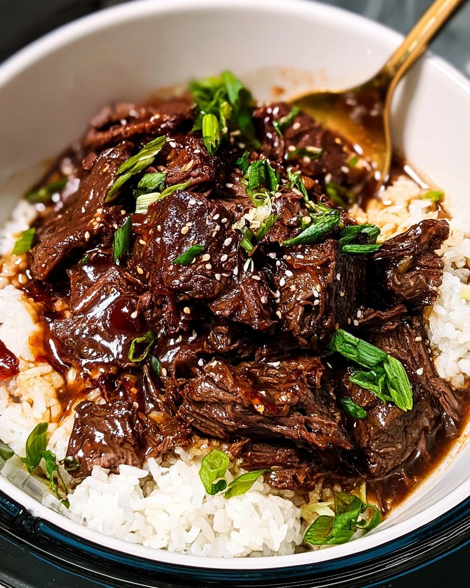 Delicious Slow Cooker Korean Beef dish garnished with scallions and sesame seeds.